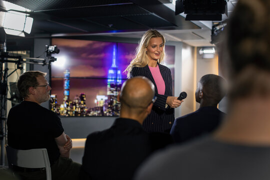 TV show host interviewing audience member