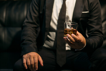 Businessmen in suits drinking whiskey