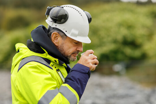 Male engineer in hard hat having drink