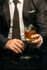 Businessmen in suits drinking whiskey