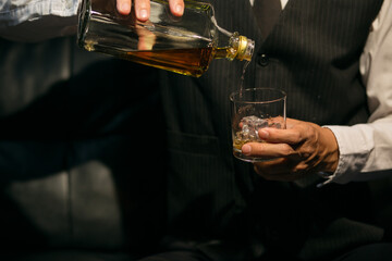Businessmen in suits drinking whiskey
