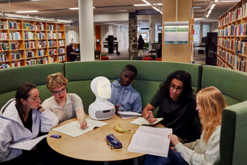 Friends sitting together in library