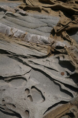 Fototapeta na wymiar texture of porous stones on the beach, nature, natural phenomena, brown-gray stones