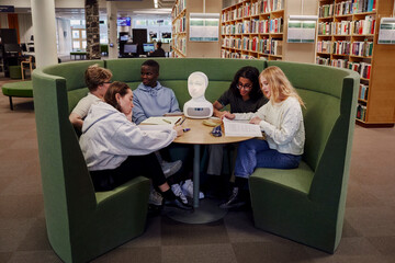 Friends sitting together in library