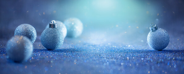 glitter baubles on a blue glitter background, background for Christmas