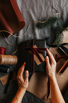 High angle view of womans hands holding wrapped present