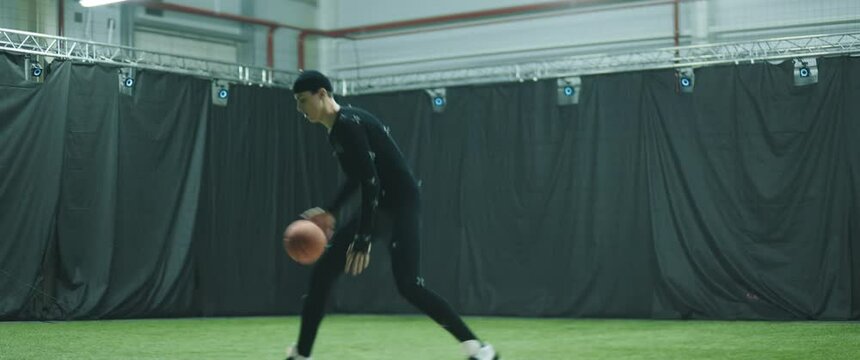 Pro basketball player in motion capture suit dribbling as a game character. Motion capture is an unparalleled method for making animated characters move more realistically