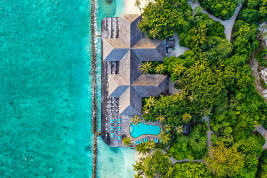 Maldives,LhaviyaniAtoll, Kuredu, Aerial view of coastal tourist resort with outdoor swimming pool