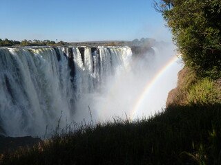 Victoria Falls of River Zambesi with two rainbows, Zimbabwean shore, Unesco World Heritage Site,...