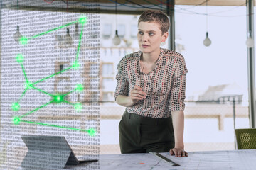 Female professional looking away near desk at office