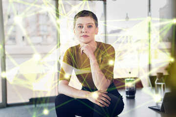 Female professional sitting on desk surrounded by global communication data at office
