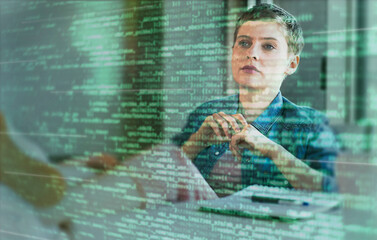 Female professional looking at binary codes on glass at office