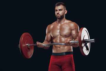 Fototapeta na wymiar Front view of a strong man bodybuilder lifting a barbell isolated on black background