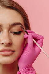 girl draws eyebrows of the model
