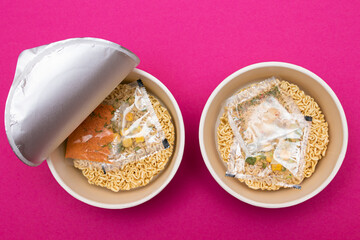 Opened Package with Uncooked Instant Noodles on Pink Background. Raw Pasta. Dry Asian Fast Food. Quick Lunch