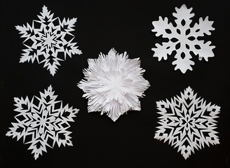 christmas snowflakes made of paper on black background
