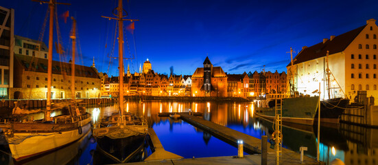 Obrazy  Old town in Gdansk with historical port crane over Motlawa river at night, Poland.