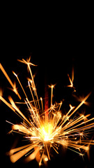 Burning sparkler on black background. Burning New Year sparkler