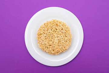Uncooked Instant Noodles on White Plate. Raw Pasta. Dry Asian Fast Food. Quick Lunch