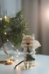 Fototapeta premium cute soft toy tiger with decorations on a cozy Christmas or New Year background. symbol of 2022, oriental calendar concept