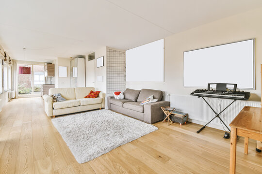 Lovely living room with milky and gray sofas and shaggy carpet