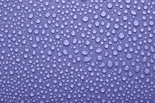 Very peri violet color water drops, abstract background or texture.