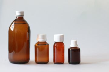 glass bottles of various sizes for medical purposes with tablets and syrups