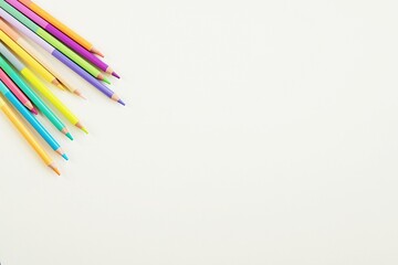 Minimal creative composition on white background with colorful pencils, art, drawing, creativity, design concept, space for text or product.