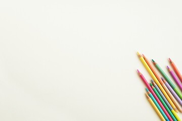 Art, drawing, creativity concept, white desk and colorful pencils, space for text or coloring pages, background mockup.