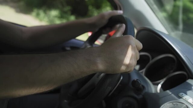 Man Driver Hand On Car Steering Wheels. Male Traveling Transportation. Driver Turning Steering Wheel In Car. Man Driving Auto. Personal Transport Controls In Car And Holding Wheel