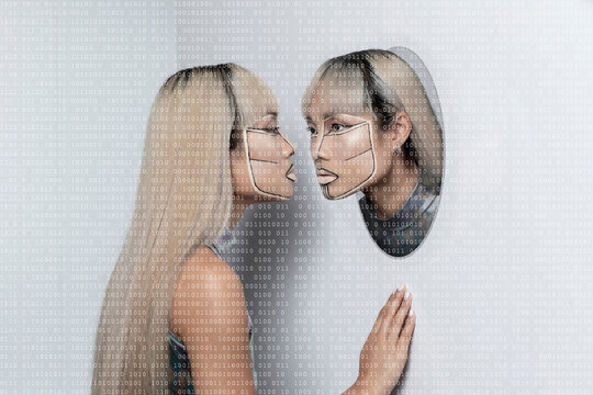 Young woman staring at female cyborg on white background