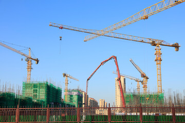 Fototapeta premium the construction worker's tower crane, Residential buildings are under construction