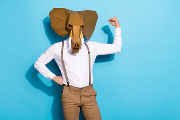 Photo of charismatic confident man wear elephant mask showing power empty space isolated blue color...