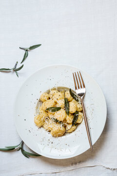 Plate of ready-to-eat Italian gnocchi dumplings with grated Parmesan cheese