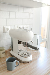 white stylish coffee machine in cozy kitchen interior