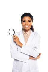 African american ophthalmologist holding magnifying glass and looking at camera isolated on white.
