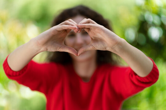 Woman making heart shape with hands