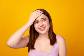 Photo of young lady arm touch forehead silly forget important information isolated over yellow...