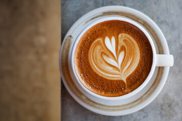 Cappuccino coffee in a beautiful glass on the table favorite cup of coffee concept.