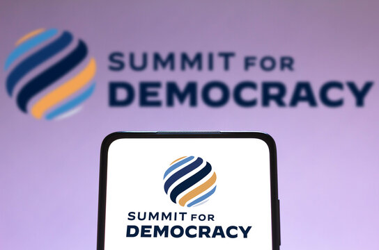 December 9, 2021, Brazil. In This Photo Illustration The Summit For Democracy Logo Seen Displayed On A Smartphone And On The Background. Is A Virtual Summit To Be Hosted By The United States.