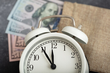 dollars and alarm clock. money and economy concept.
