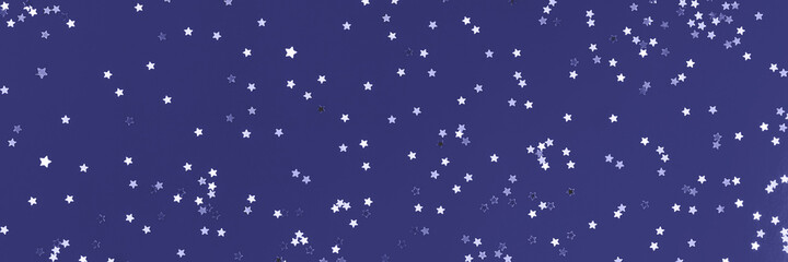 Festive violet blue paper background with many many silver stars. Christmas, New Year or Birthday theme concept. An ideal backdrop for your banner or web design. Banner for happy holidays presentation