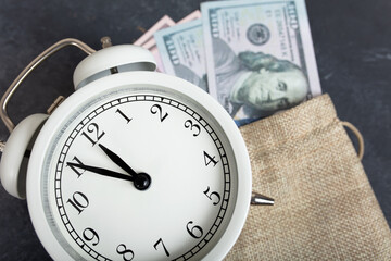 dollars and alarm clock. money and economy concept.
