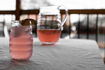 Close up of Pink lemonade with lemon wedge on table