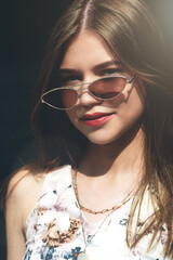 Close up fashion portrait of pretty girl, have long amazing brunette hairs, wearing vintage sunglasses, and bright lipstick