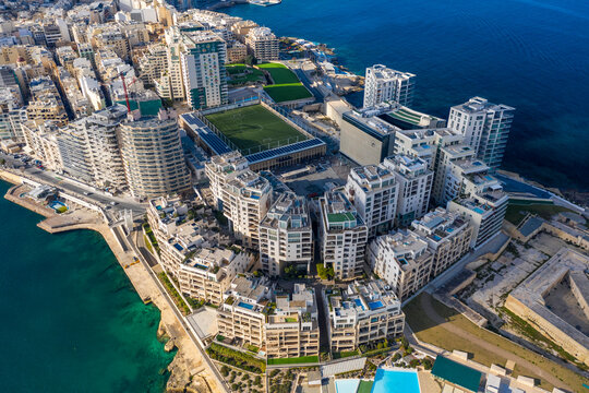 Malta, Central Region, Sliema, Aerial view of soccer field, apartments and hotels of Tigne Point peninsula