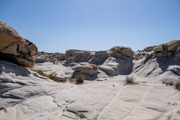 Granite grey rocks shaped by the sea salt and wind background. Kolymbithres Paros island Greece.