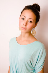 young brunette woman dressed like ancient greek godess, gold jewelry close up isolated