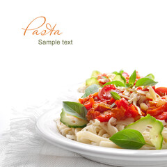 Pasta with tomato sauce basil and grated parmesan on the white plate