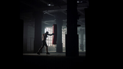 Athlete performing physical exercises. Afro man doing boxing training in gym - Powered by Adobe